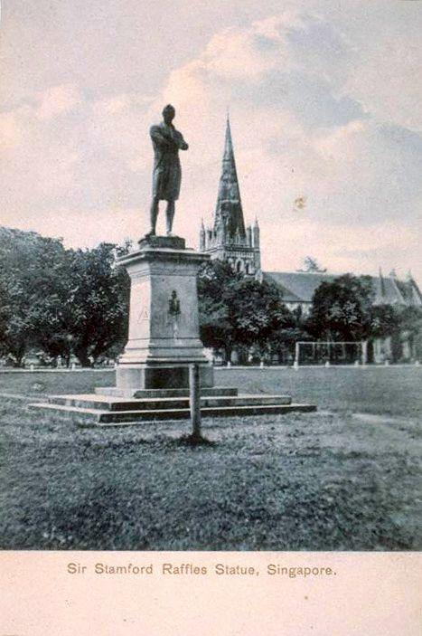 Statue of Sir Stamford Raffles at its first location at the Padang, Singapore, between St Andrew's Road and Connaught Drive, and facing the sea. In the background is St Andrew's Cathedral.