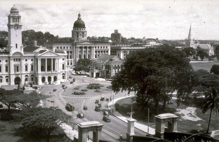 View of Empress Place and its vicinity, Singapore. Buildings include, clockwise from left,  Victoria Theatre and Memorial Hall (with clock tower), Supreme Court (with dome), Cathay Building (background), St Andrew's Cathedral (with spire) and Singapore Cricket Club (centre, foreground).