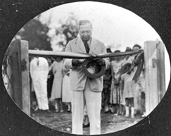 The Honorable Dr Noel L Clarke cutting ribbon to open the Singapore Girls' Sports Club