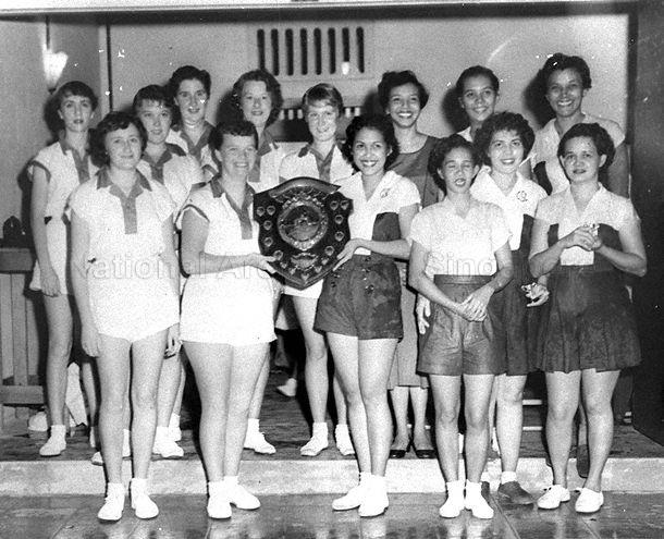 Group photograph of netball teams from Singapore Girls' Sports Club (right) and Women's Royal Army Corps (WRAC) during the competition for the Clarke Netball Challenge Shield