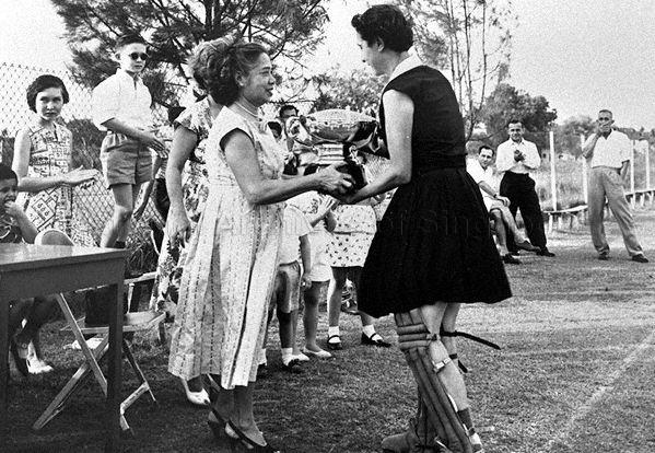 Mrs R Pearse presenting the "Lily Pearse" Rose Bowl to winners of the annual hockey competition at Girls' Sports Club
