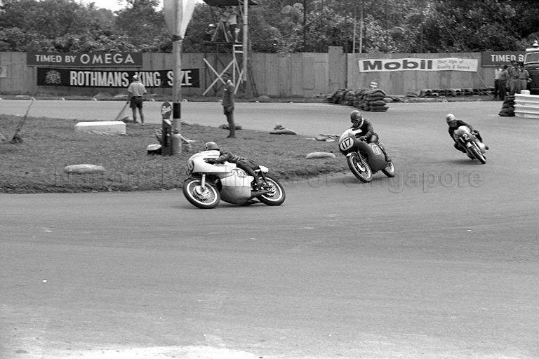Hiroshi Hasegawa on his Yamaha leading Yoshimi Katayama on a Suzuki and another rider around Sembawang hairpin, during Singapore Grand Prix 1966 held at Thomson Road circuit