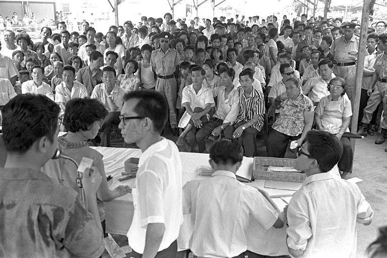 Registered hawkers balloting for hawker stalls at Bukit Ho Swee, 1966. A new Hawkers Code was implemented in 1966 for licensing and controlling hawkers. Since then, street hawkers were progressively relocated into markets and shophouses with running water, electricity and proper refuse disposal facilities. They also had to comply with minimum public health requirements and empty all refuse at proper public refuse bins. Food and drink hawkers were tested for communicable diseases such as tuberculosis and cholera