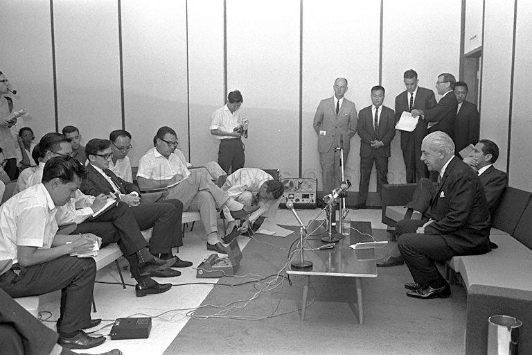 Australian Prime Minister Harold Holt (seated right) holds press conference before leaving Singapore for Kuching, Sarawak after his visit to Singapore.