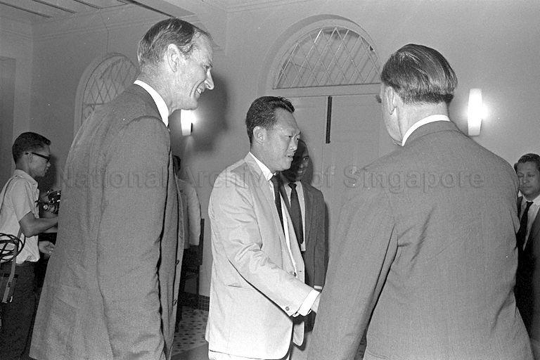 Prime Minister Lee Kuan Yew exchanging greetings with British official during British Foreign Secretary Michael Stewart's call on the Prime Minister at Sri Temasek. Looking on is British High Commissioner J V Rob (left).