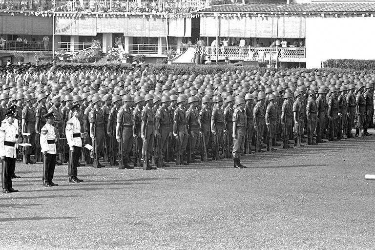 National Day Parade 1966 at the Padang - People's Defence Force contingent assembled on the field; amongst the members are Minister for Education Ong Pang Boon, Minister for Labour Jek Yeun Thong, Minister for Culture and Social Affairs Othman Wok, and Minister of State for Defence Wee Toon Boon, in the ranks of officer cadets