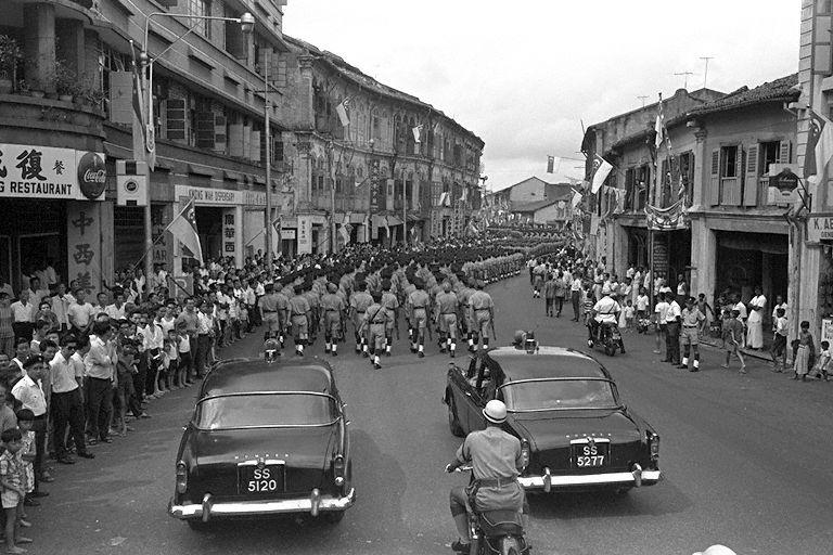 Contingent from Singapore Police Force marching down Tanjong Pagar Road after the National Day Parade at Padang, watched by spectators lining both sides of the road
