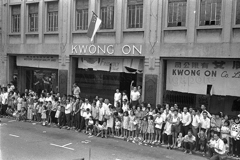 National Day Parade 1966 at the Padang - Spectators in Chinatown lining the roadside to watch the parade