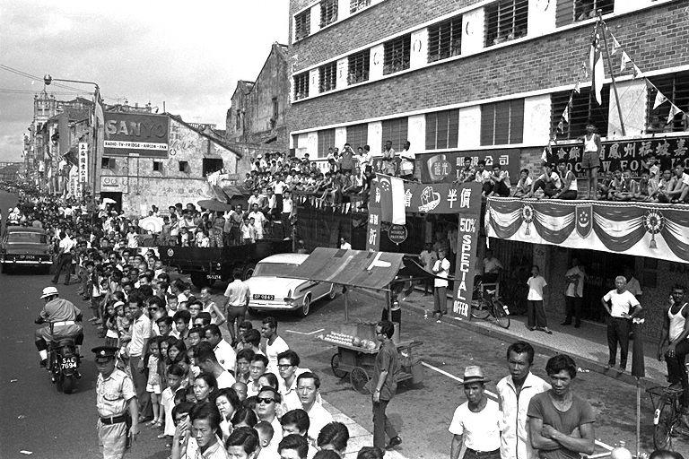 National Day Parade 1966 at the Padang - Spectators gathering around the building and lining along South Bridge Road to watch the parade