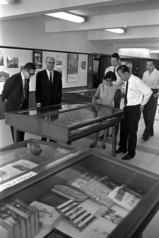 French Charge D'Affaires Edouard Hutte and Parliamentary Secretary to Ministry of Culture Fong Sip Chee viewing books on display at National Library in Stamford Road during presentation of books donated by French Government