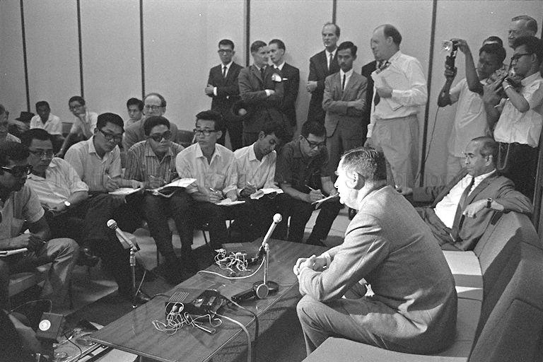 British Defence Secretary Denis Healey giving a press conference upon his arrival at Paya Lebar International Airport. Seated beside him is Minister for Foreign Affairs S Rajaratnam.