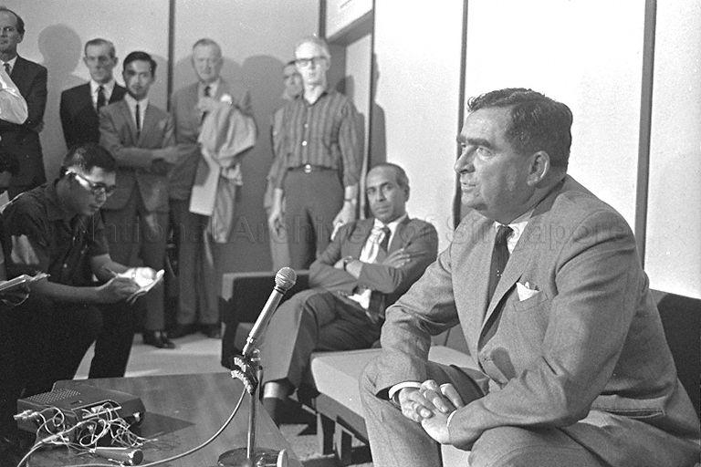British Defence Secretary Denis Healey giving a press conference upon his arrival at Paya Lebar International Airport. Seated beside him is Minister for Foreign Affairs S Rajaratnam.