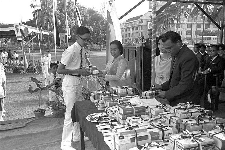 Jimmy Hsu receiving his prize for first in Standard Secondary 2 (1966) from wife of Minister for Culture and Social Affairs Mrs Othman bin Wok during Raffles Institution's Speech Day prize giving ceremony