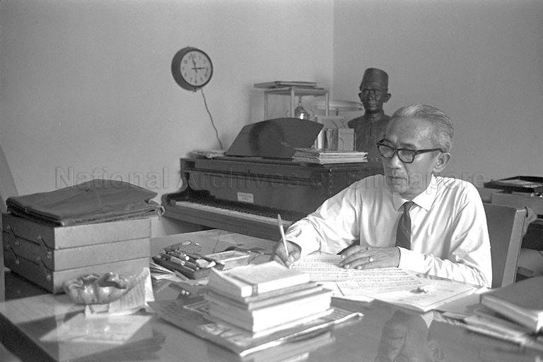Composer of Singapore's National Anthem Zubir Said (wearing a tie) writing music scores on his music sheet at his home in Joo Chiat Place