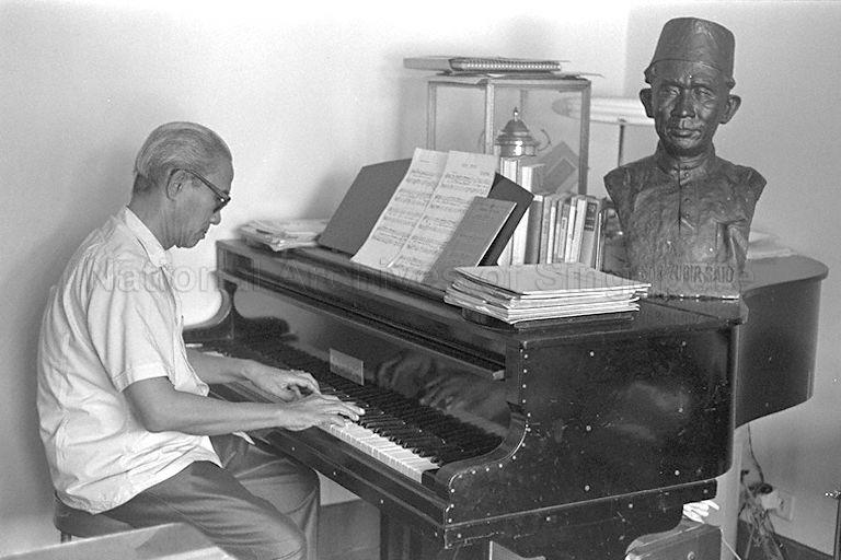 Composer of Singapore's National Anthem Zubir Said (wearing light-coloured shirt) playing a piano at his home in Joo Chiat Place