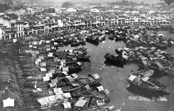 Aerial view of Boat Quay with tongkangs and twakows in the Singapore River and shophouses and godowns along the banks