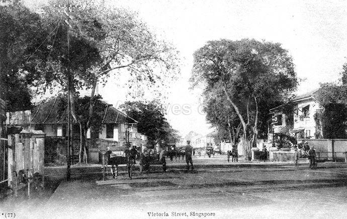 View along Victoria Street, Singapore, at junction with Stamford Road. Part of Hotel van Wijk can be seen on the right.