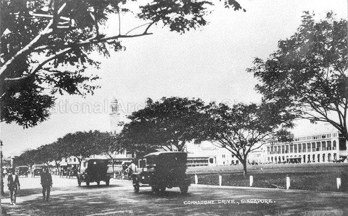 Connaught Drive, Singapore, with the Europe Hotel visible on right and clock tower of Victoria Memorial Hall in the background