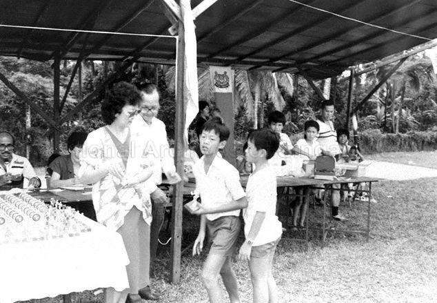 Prize presentation during Nee Soon Primary School's Sports Day. Mr Sasi, teacher-in-charge of the school's badminton team, is seated on left.