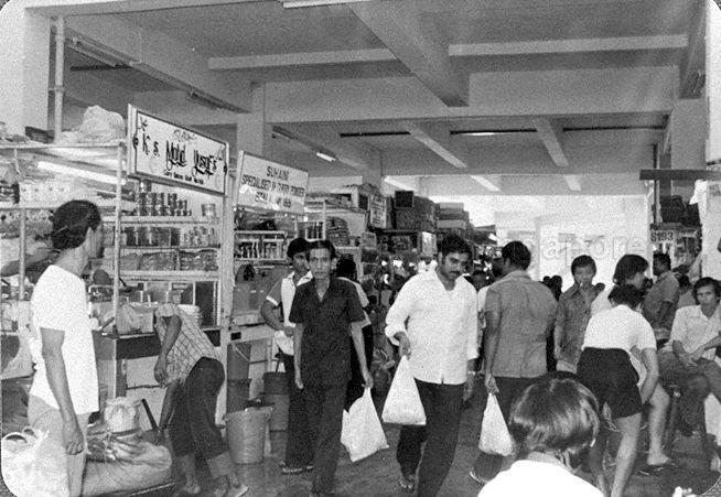 The newly-opened Zhujiao Centre or Tekka Centre (as it was renamed in 2000). The market was originally located between Hastings Road and Sungei Road, and first known as Kandang Kerbau (or just KK), Malay for "buffalo pens", referring to the slaughterhouses operating in the area until the 1920s. It was also known as Tek Kia Kha, in Hokkien where it means "foot of the small bamboos", because bamboo plants once grew on the banks of the Rochor Canal. Its name was later adapted to Tekka Pasar, where pasar is Malay for "market".