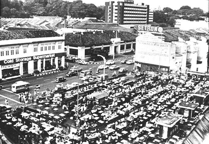 Street hawker stalls at the old Glutton's Square, opposite Cold Storage (now Centrepoint) at Orchard Road. Glutton's Square was closed in 1978 and most of the hawkers relocated to Newton Food Centre while the rest moved to the nearby Cuppage Road Food Centre.