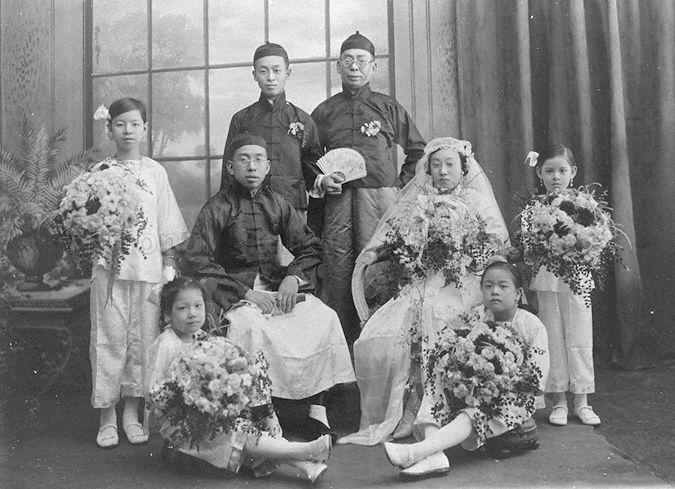 This is the wedding photo of Anthony Low Hua Mong (second from left). He is the son of Philip Julian Low Gek Seng and Mary Teo Ah Phang. <br />Anthony Low's bride is Cecila Wee Sai Cheng (second from right). She is the daughter of Wee Cheng Soon and Regina Tan. <br />They are prominent and wealthy Teochew families in Singapore. Both families are prominent Roman Catholic church philantropists, going back to the 1850s and especially so from the 1890s until the 1940s. <br />The tallest standing man is Philip Julian Low Gek Seng, father of the groom. The little girl on the extreme right is Mary Low. Mary Low is the niece of the groom and granddaughter of the groom's father.<br />The solemnization of the marriage of Mr Low Hoa Mong, Anthony and Miss Wee Sai Cheng, Cecilia was on Thursday, 20th September 1923. Loa Hoa Mong was the youngest son of Mr. P. J. Low Gek Seng and grandson of Mr Low Kiok Chiang. Wee Sai Cheng was the eldest daughter of Mr Wee Cheng Soon, a prominent contractor.