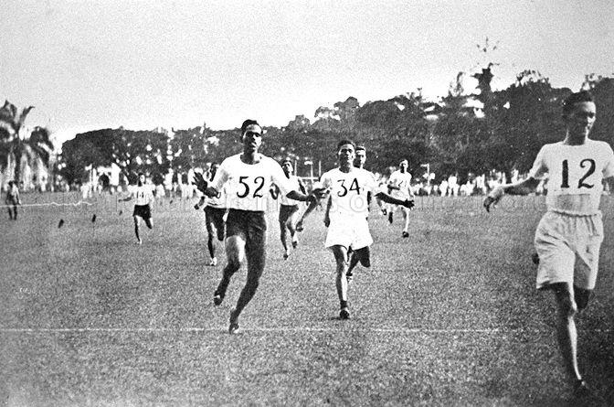 Jocelyn de Souza wearing tag number 12 competing in the Malayan AAA championships over 220 yards race in Kuala Lumpur