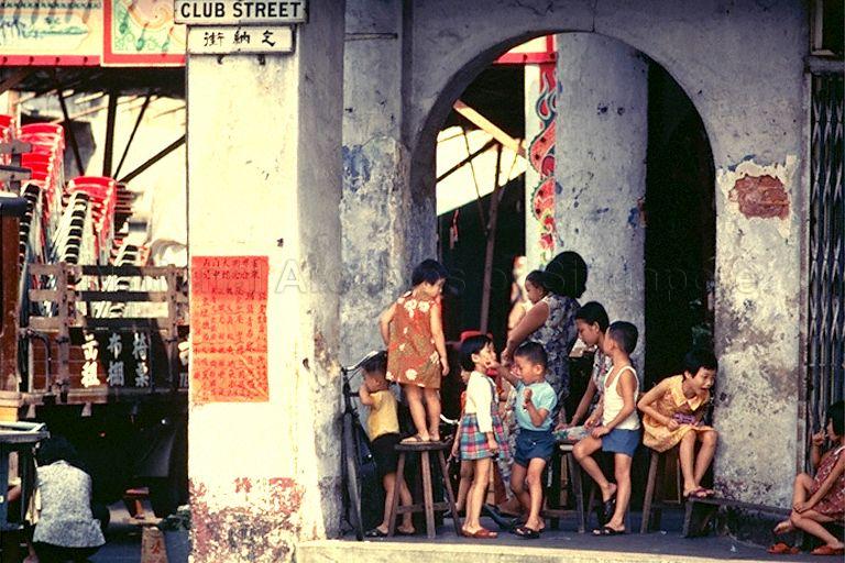 Children playing at five-foot-way of shophouses along junction of Club Street and Gemmill Lane