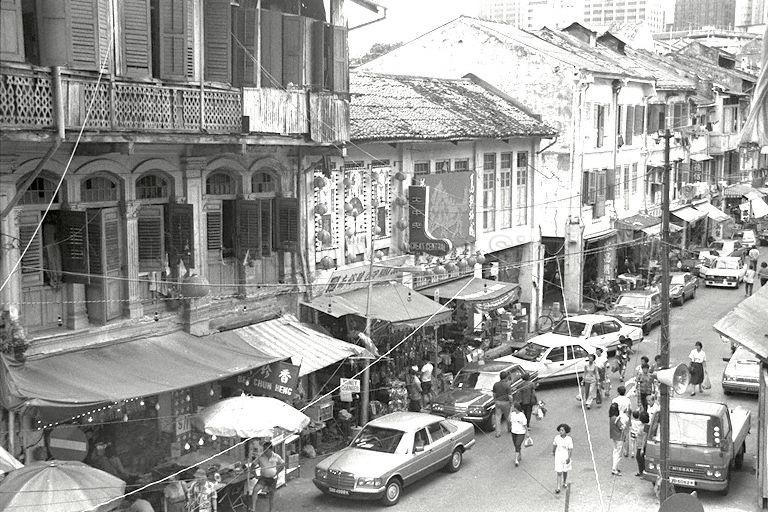 View of Smith Street in Chinatown. In the early days, the street was popularly known as "hai yuen kai" in Cantonese or theatre street, with reference to the former Chinese theatre Lai Chun Yuen (three-storey building partially seen on the left) which often staged Cantonese opera.