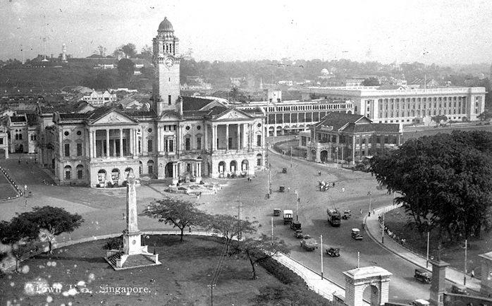 View of Empress Place, Singapore. On the left in the foreground is the Dalhousie Obelisk and buildings, from left, include Victoria Theatre and Memorial Hall, the Europe Hotel, Municipal Building (now City Hall) and Singapore Cricket Club (centre, right).