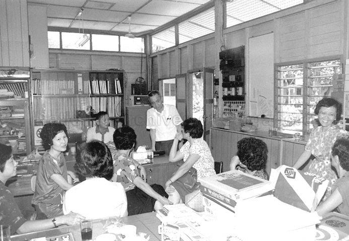 Former principal, Teo Kian Chow (standing, centre), and teachers of Thomson Shin Min Public School gathering at staff room before closure of the school