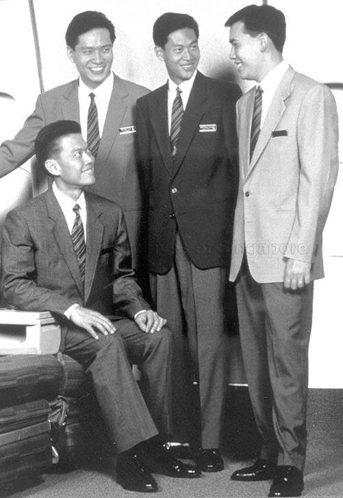 Singapore Airlines (SIA) flight stewards in their uniform of business jackets, grey trousers and striped ties. The colours of their jackets distinguish their ranks -- (from right) light blue for flight steward, navy blue for chief steward, sky blue for leading steward and grey for in-flight supervisor.