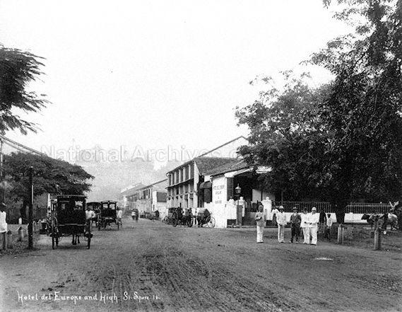 View of High Street, with Hotel De L'Europe on the right. Fort Canning Hill can be seen at end of the street, in the background.