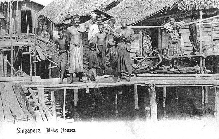 Orang laut (native malays) of Pulau Brani posing in front of their houses on stilts, Singapore