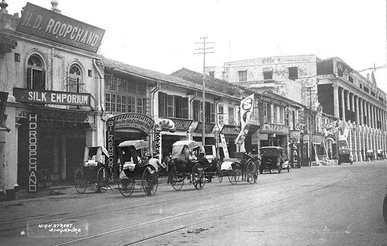 View of High Street, Singapore. On the left is H D Roopchand Silk Emporium at 14 High Street.