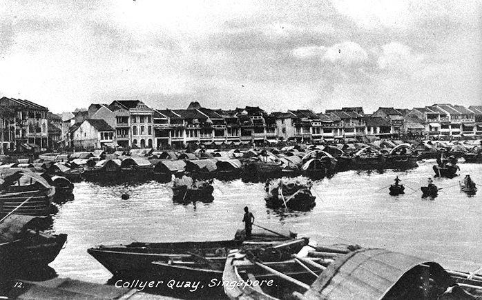 View of shophouses and twakows in the Singapore River at Boat Quay