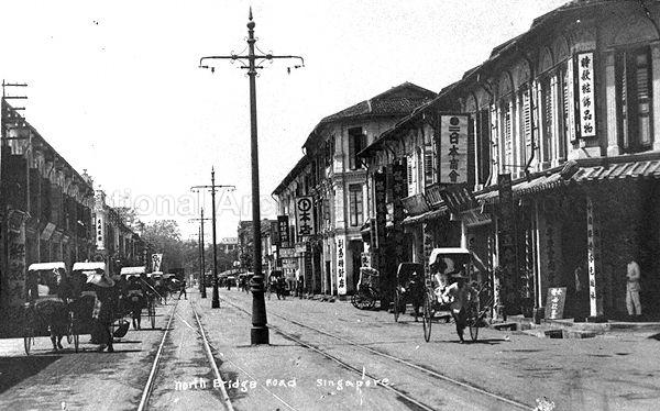 North Bridge Road looking from Purvis Street toward Bras Basah Road. Seah Street is on the left behind 2 parked rickshaws. Japan Association is in the picture and is located at No.331