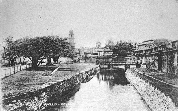 Fort Cornwallis and moat surrounding the fort, Penang. The Jubilee Clock Tower is in the background on the left.