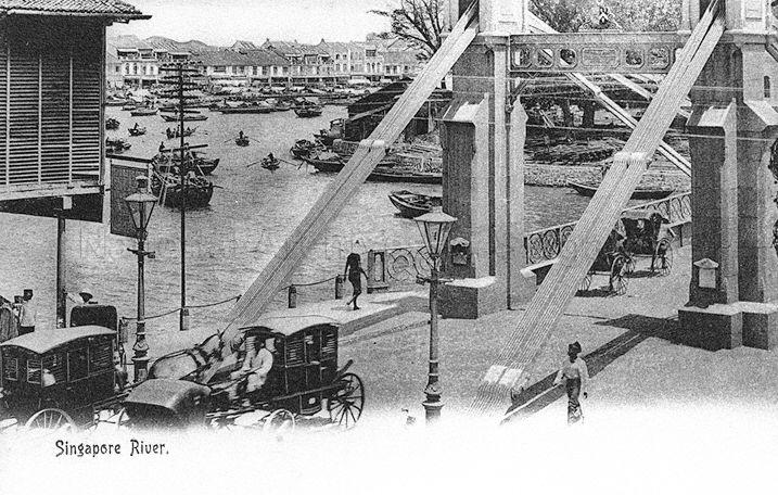 Cavenagh Bridge overlooking the Singapore River. This picture was taken before status of the bridge was reduced from major thoroughfare for wheeled traffic to footbridge in 1910, with a ban on bullock carts, horse carriages and vehicles exceeding three hundredweight (152 kg)