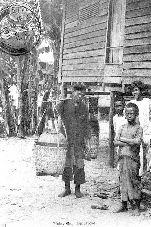 Malay "kueh" or cakes hawker carrying his wares and Malay boys in a "kampong" or village, Singapore