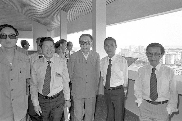 Housing and Development Board (HDB) Deputy Chief Executive Officer Chong Kim Chang (second from left), People's Republic of China Foreign Minister Wu Xuequian (third from left) and HDB Chief Architect Tony Tan Keng Joo (fourth from left) touring the National Development Building at Maxwell Road.