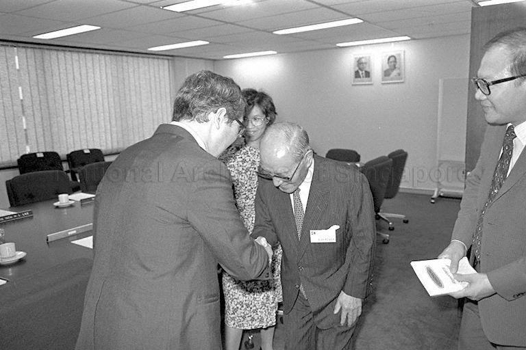 Keidanren (Japan Federation of Economic Organizations) Chairman Yoshihiro Inayama (centre) shaking hands with a Singapore official at the Central Provident Fund building.