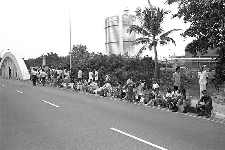 National Day Parade 1985 at National Stadium -- Spectators waiting to view parade along the street