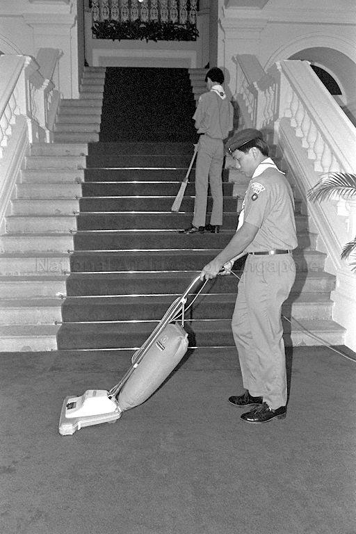 Colin Tham Hsien Jen (top) and John Pok Liwen (bottom) from Anglo Chinese School cleaning the lush red carpet at Istana where President Wee Kim Wee, Chief Scout of Singapore, launches Scout Job Week to raise funds for the scouts' training programme and activities.