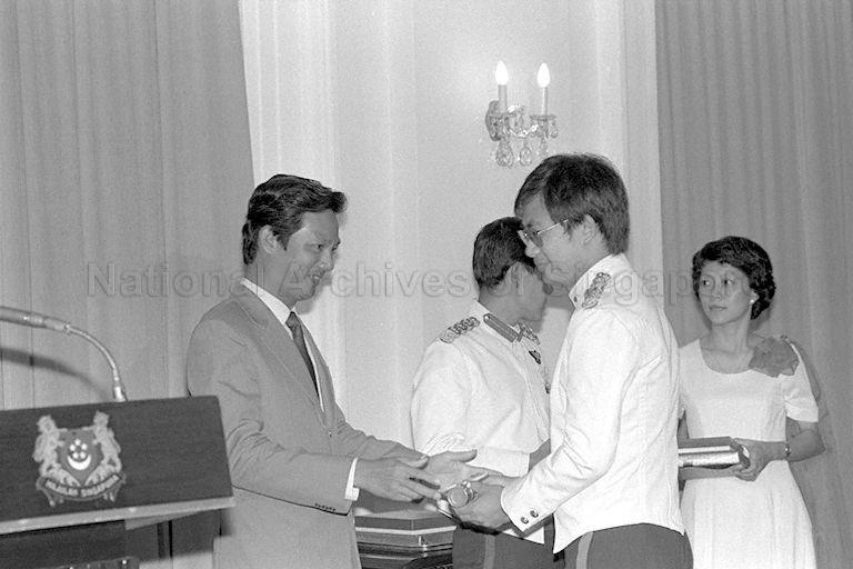 Minister for Communications and Information and Second Minister for Defence Dr Yeo Ning Hong (left) presenting award during the Third Reservist Officers' Staff Course graduation ceremony at Istana