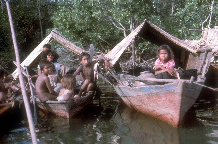 Orang Laut (Sea People) families on board their houseboats known as 'sampan panjang' or long boats