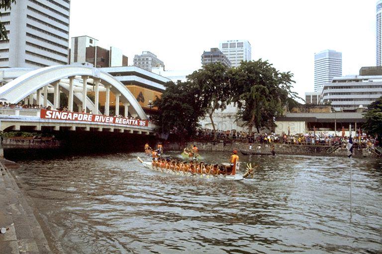 Dragon boat race at 3rd Singapore River Regatta at Singapore River with Elgin Bridge in background