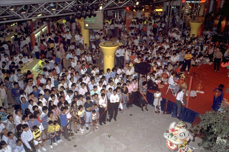 Aerial view of crowd watching lion dance performance at Chinese Heritage Exhibition at the atrium of Raffles City shopping centre, 252 North Bridge Road. The exhibition was organised by the Singapore Federation of Chinese Clan Associations in conjunction with Chinese Cultural Month and to celebrate the 25th anniversary of Singapore's independence.