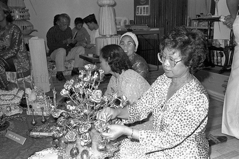 A display of 'gift items' fit for weddings in Malay culture which include 'bunga rampai' (usually made of finely shredded pandan leaves and flower patels tossed in perfumes) and 'telor paha' (tall bouquet decked with boiled eggs and flowers individually put together and mounted into a big lump of moulded yellow sticky rice called 'pulut kuning') during opening of folk arts and craft exhibition at Singapore Conference Hall. Also on display are other carefully decorated items such as mosque structure.