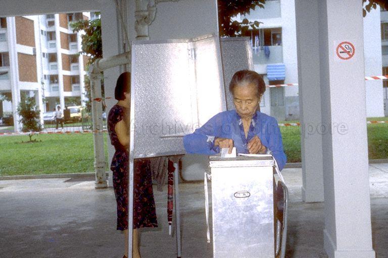 1988 General Election - An elderly Chinese lady slipping her ballot slip into ballot box at polling station